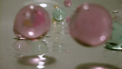 Water beads slow motion bouncing Stock Footage 144704222