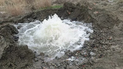 Water beats out of the ground from a broken volovod. Communal economy Stock Footage 244529026