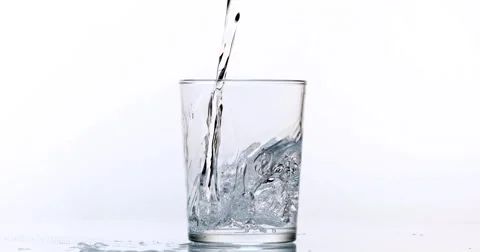 Water being poured into Glass against White Background, Slow Motion 4K Stock Footage