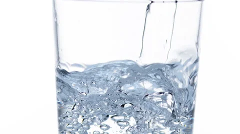 Water being poured into Glass against White Background, Slow Motion Stock Footage