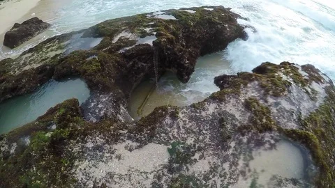 Water is being recruited into a slit on the beach and sprinkled with force Видео 88620643