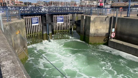 Water being released from a sea lock Stock Footage 239656149