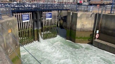 Water being released from a sea lock Stock Footage 239656358