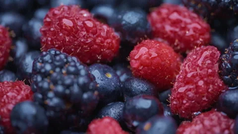 Water being sprayed over fresh organic berries Stock Footage 276382995