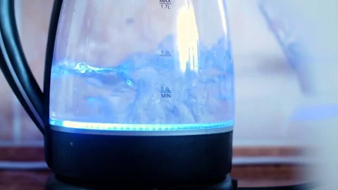 Water boiling in black kettle Stock Footage 77215079