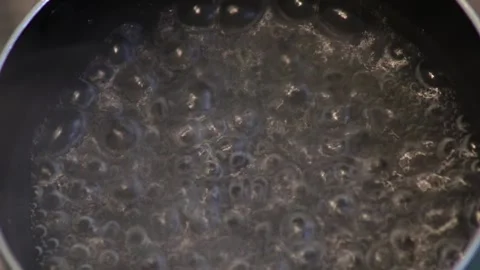 Water boiling with bubbles  Stock Footage 268744646