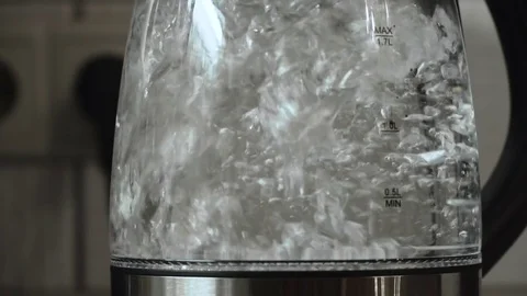 Water boiling with bubbles in transparent electric pot, slow motion Stock Footage 84277745
