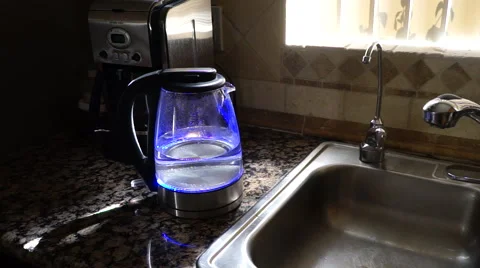 Water boiling in a clear see through LED tea kettle Stock Footage 47331380