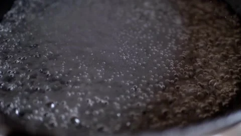 Water Boiling in a Dark Pan, Close-Up Stock Footage 317562220