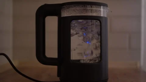 Water is boiling in a glass kettle Stock Footage 325435610