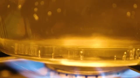 Water is boiling in a pan close-up. Boiling water in a transparent pan. The proc Stock Footage 283412064