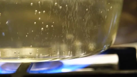 Water is boiling in a pan close-up. Boiling water in a transparent pan. The Stock Footage 283815820