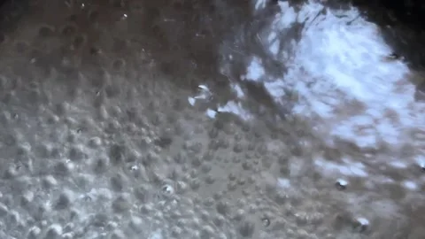 Water is boiling in a saucepan, contrast and shadows. Stock Footage 282958305
