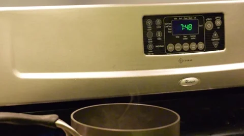 Water Boiling on Stove with clock Video stock 67366430