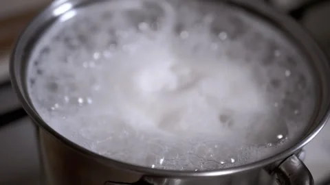 Water boiling vigorously in a pot Stock Footage 306779226