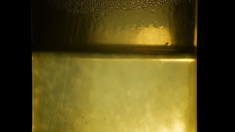 Water boiling violently inside an old kettle (macro shot) Stock Footage 94148786