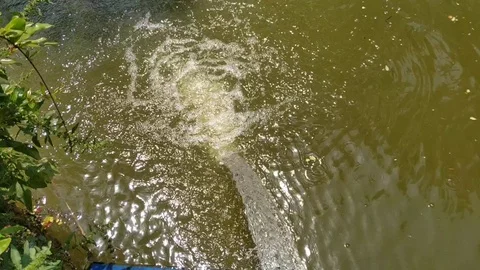The water is boiling with water while falling in the pond. Stock Footage 128830132