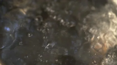 Water boiling,Close-up in pot of boiling water,Bubbles of boiling water Video stock 133356679