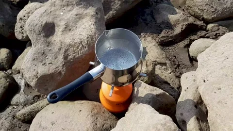 Water boils while making coffee on a portable gas stove close-up Stock Footage 161978852