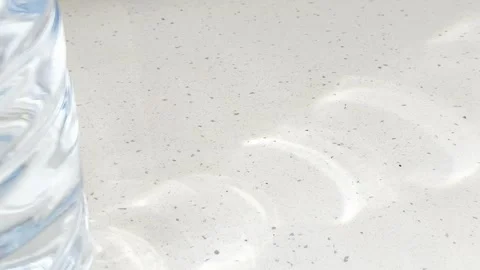 Water bottle casting dancing caustic reflections and moving shadows on a br.. Stock Footage 335139482