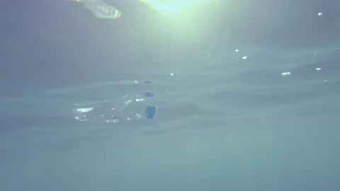 Water bottle ocean plastic floating at sea threatening the health of the planet Stock Footage 128171795