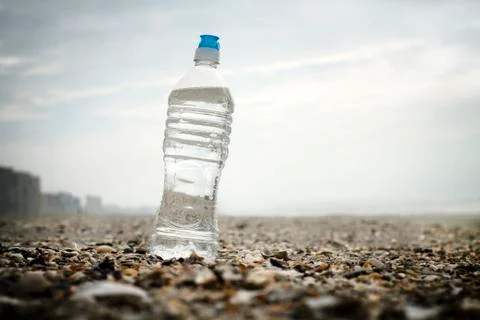 Water Bottle On Shells At The Beach - no people Stock Photos