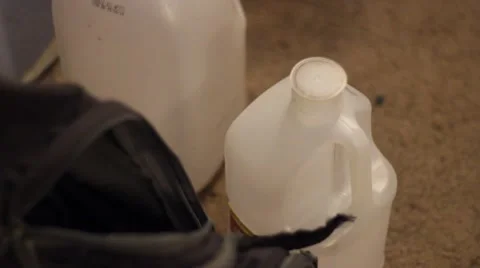 Water bottles next to backpack Stock Footage 47529211