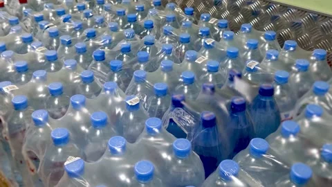 Water bottles in a package stand in rows together, awaiting dispatch Video stock 153395460