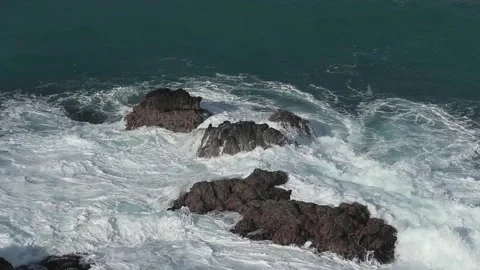 Water breaking over rocks on a tropical rocky beach in puerto rico Video stock 276805997