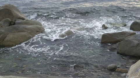 Water breaking on the stone shore, slowmo Stock-Footage 84201569