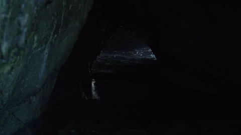 Water breaking through cave Stock Footage 260370337