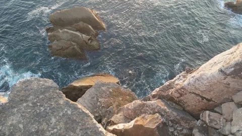 Water breaks on cliff rocks Stock Footage 339645530