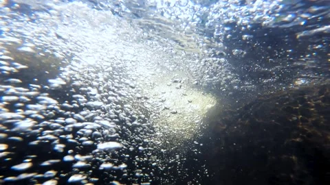 Water bubble in a flowing stream through rock Stock Footage 308151738