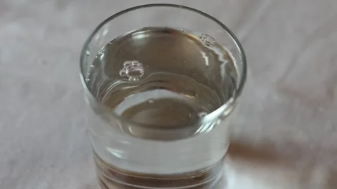 Water bubbles bursting inside a glass of water Stock Footage 339707905