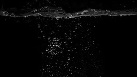 Water bubbles floating on black background Stock Photos