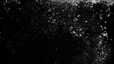 Water bubbles floating on black background Stock Photos