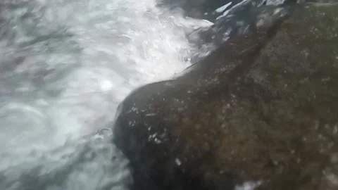 Water bubbles flowing on the rocks Stock Footage 221009250