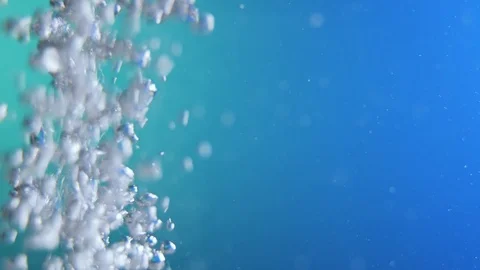 Water bubbles in front of blue and green background Stock Footage 106076272