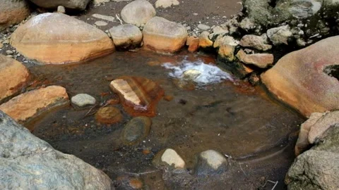 Water bubbles from a hot spring containing sulfur Stock-Footage 292673186