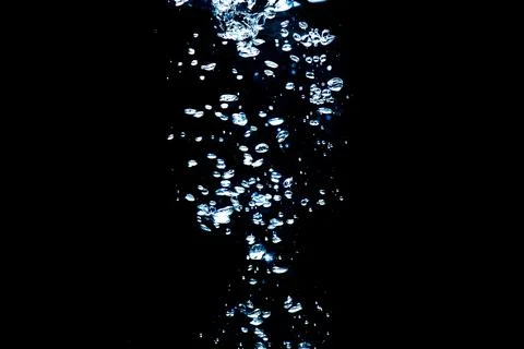 Water bubbles isolated on black background, close up view. Rippling liquid su 写真素材