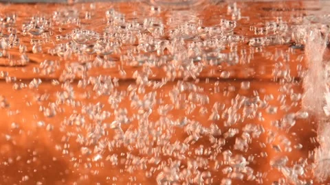 Water bubbles on orange Stock Footage 228824004