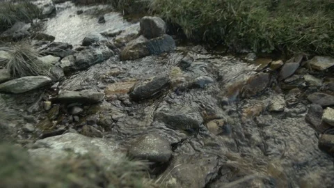 Water bubbling over rocks in a small stream in slow motion Stock Footage 86749224