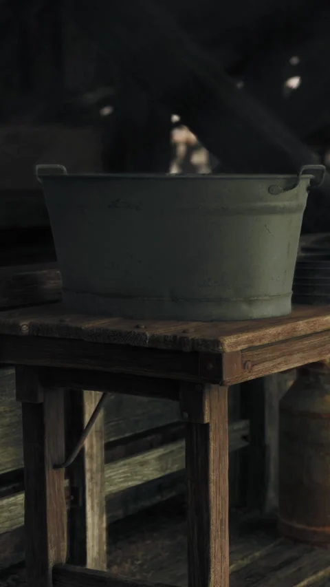 Water bucket on wooden table in rustic setting during daylight hours Stock Footage 337996135