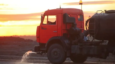 Water cart at opencast mining. Sunset Stock Footage 61851093