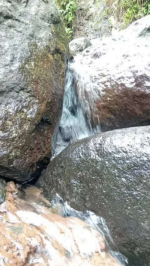 Water Cascade Between Large Rocks in Tropical Forest Stream Close-Up Stock Footage 330582341