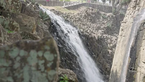 Water cascade flowing down unique geometric basalt rock formations in hidalgo Stock-Footage 342041723