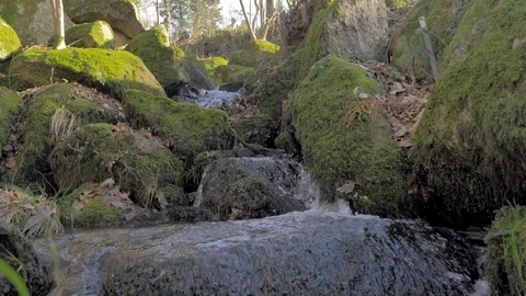 Water cascade of mountain between green mossy rocks in slow motion Stock Footage 124494648