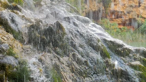 Water cascade rain falling on stone in slow motion Stock Footage 124389968