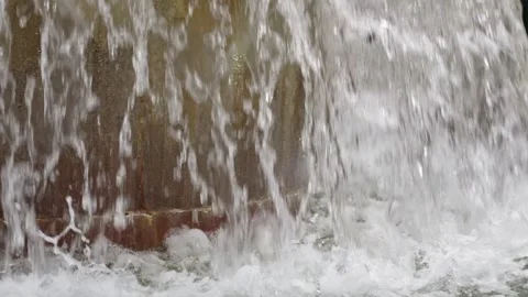 Water cascades down creating a soothing ambiance at dawn Stock Footage 308809682