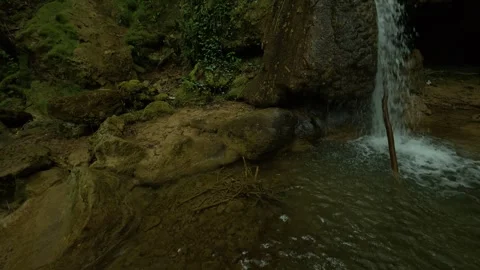 Water cascades down mossy rocks. Sokobanja, Serbia. Slowmotion Stock Footage 335923099